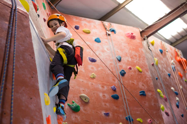 istock Portrait of determined boy practicing rock climbing 830065982