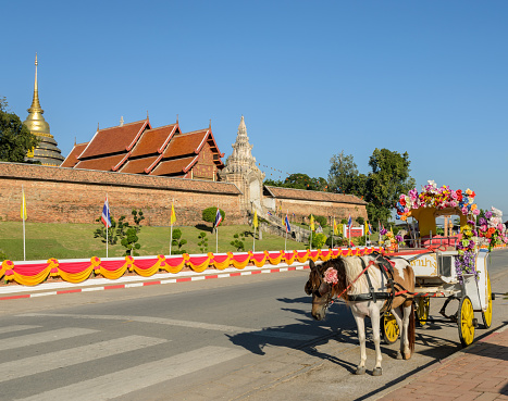 Lampang, Thailand - November 23, 2015 : Tourist horse-drawn taxi at ancient temple of Wat Phra That Lampang Luang in Lampang province,Thailand