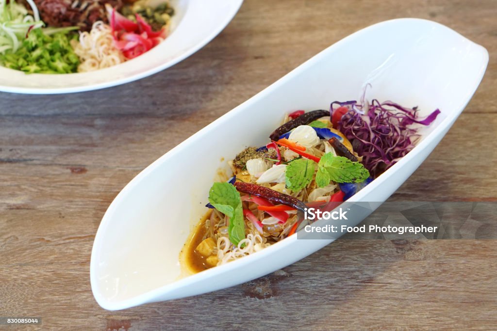 Pomelo salad thai style, mixed with purple cabbage, butterfly pea, torch ginger, chili and mint - Veganism Food is the practice of abstaining from the use of animal products. Antioxidant Stock Photo