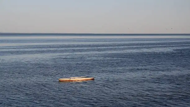 Flat bottom fishing boat anchored in the venetian adriatic sea background