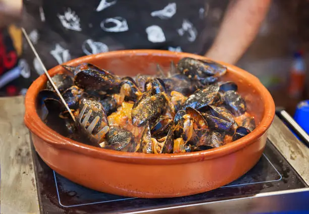 Photo of Street market stand near Barcelona Cathedral plaza,  Mussels preparation