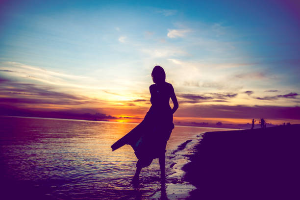 istock Woman Silhouette on the Beach 830109524