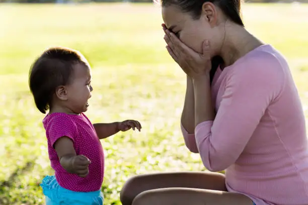 2 year old girl crying to her stressed mother