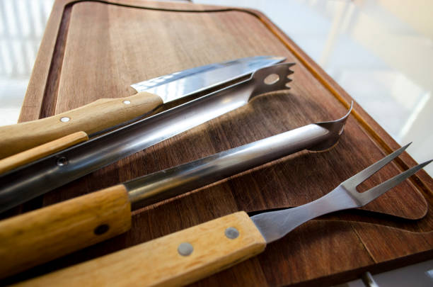 istock Empty chopping board with a sharp paring knife, fork and catcher on a blank wooden table 830151456