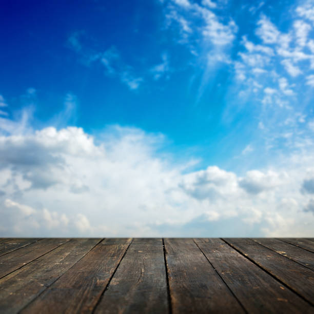 istock Wooden background and defocused sky on background 830158762