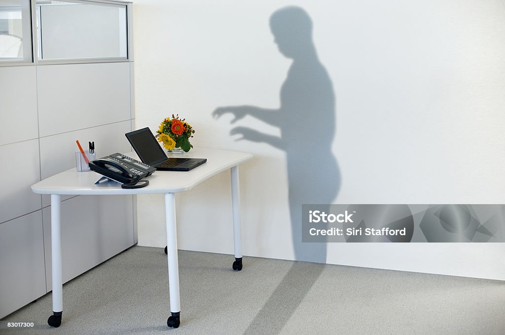 shadow attempting to use office equipment  Desk Stock Photo