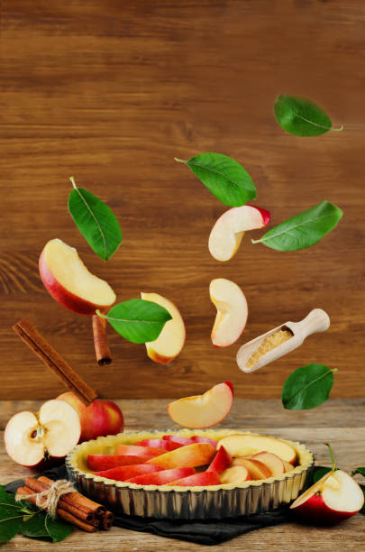 istock Apple cake with flying ingredients to bake it 830177932