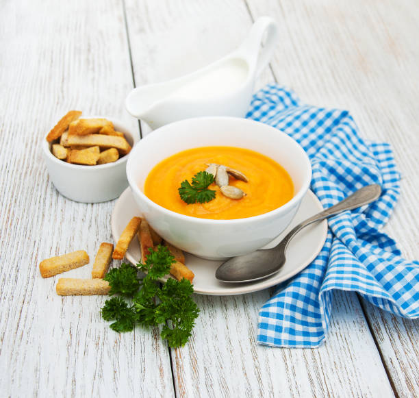istock Pumpkin soup with fresh pumpkins 830185456