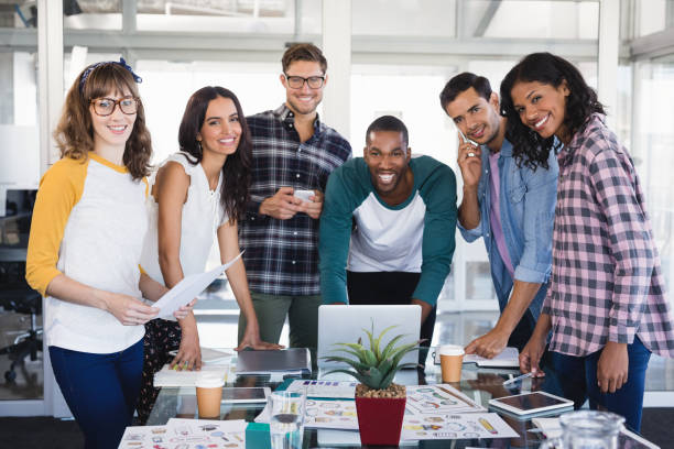 istock Portrait of creative business team standing around table 830187124