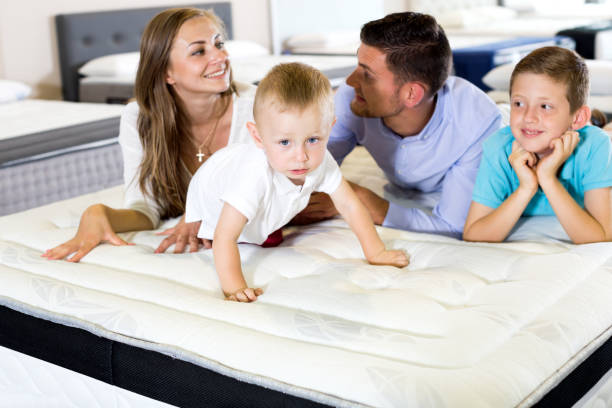 istock Little boy and parents testing mattress 830187716