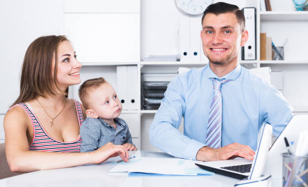istock manager of insurance company talking with female 830188080