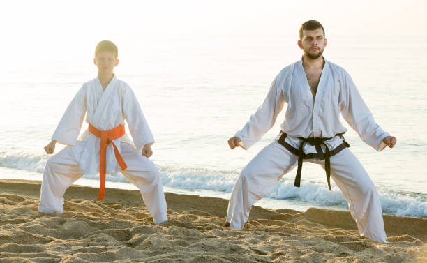 istock Man and boy doing Taekwondo 830192688