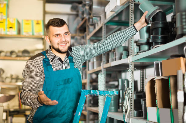 istock Man worker looking through sanitary drain pipes 830192950