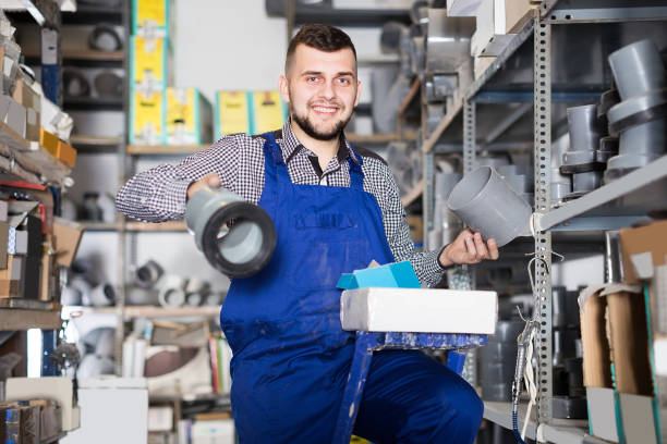 istock Adult man worker looking through sanitary drain pipes 830193044