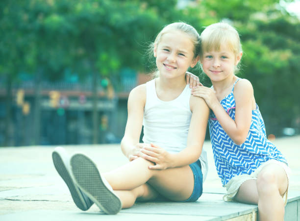 istock Two smiling little girls embracing 830194154