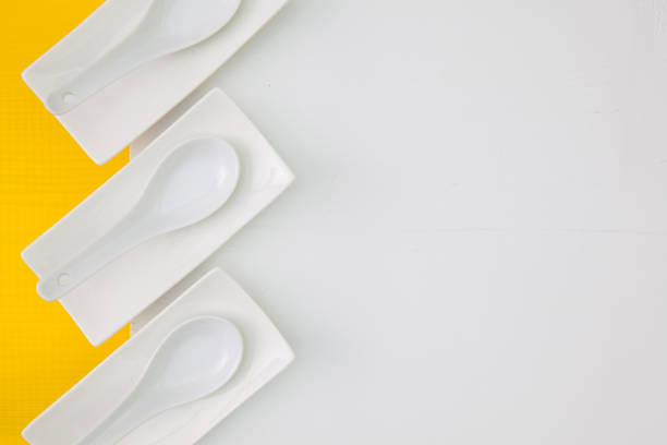 Ceramic bowls for sushi food on the yellow  and white wooden table