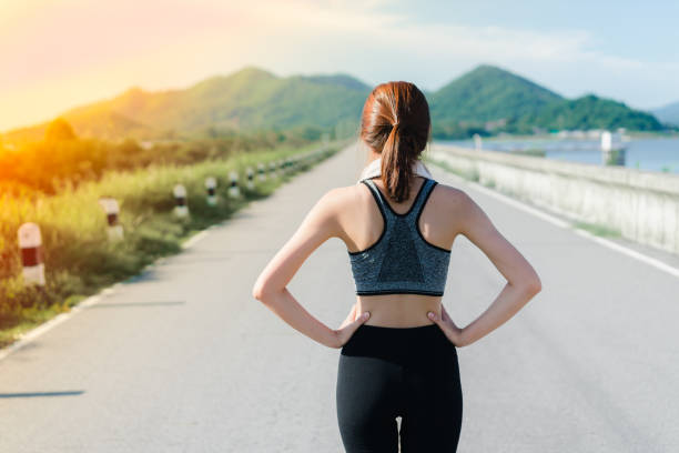 istock Young girl asian standing exercise back view and nature 830217170