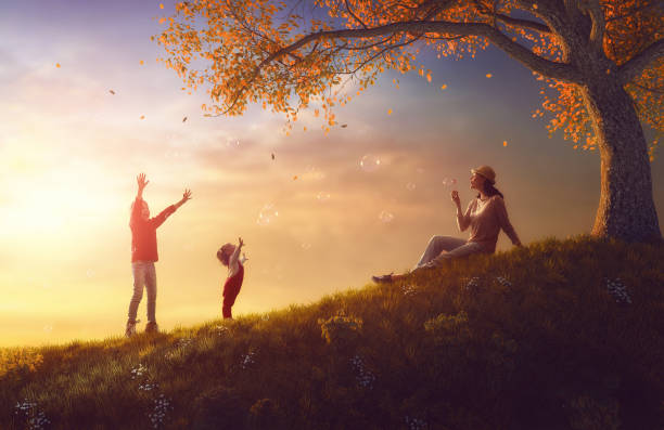 istock Mother and children playing on autumn walk 830231626