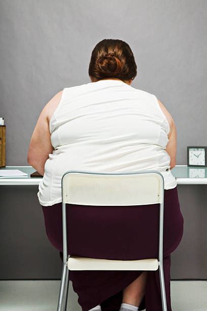 overweight woman in chair, back view - 7002 뉴스 사진 이미지