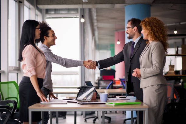 istock Multiethnic business teams at meeting room shaking hands. 830239562