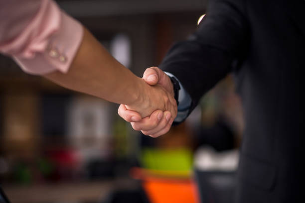istock Close up view of business partners shaking hands. 830239832