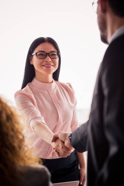 istock Business woman shaking hands with a partner. 830241874