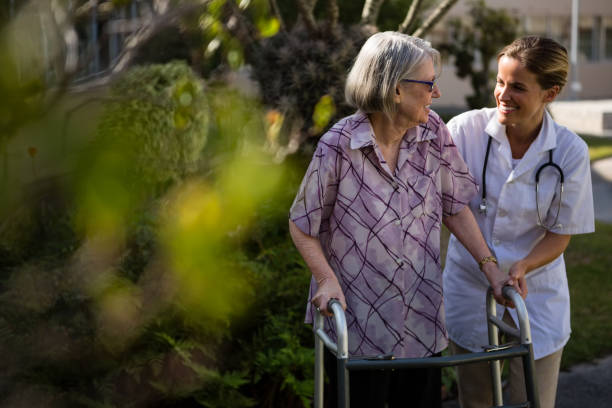 istock Doctor talking to woman while assisting her in walking 830246492