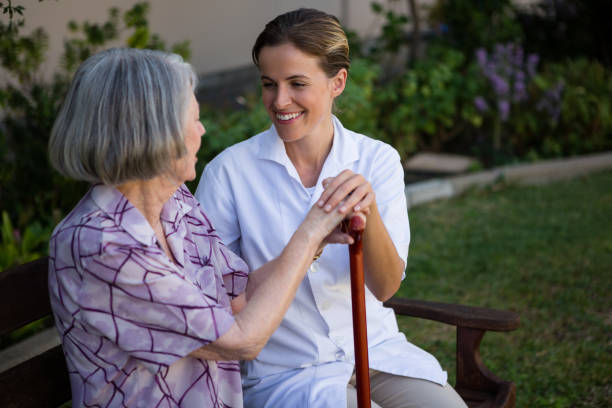 istock Woman talking to doctor while sitting on bench at park 830252644