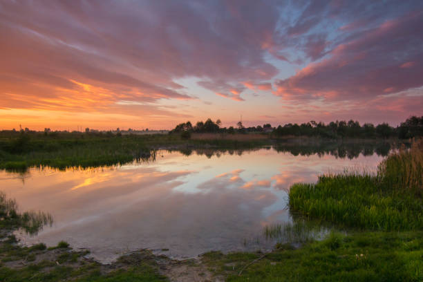 istock colorful cloudy sunset at countriside lake 830268940