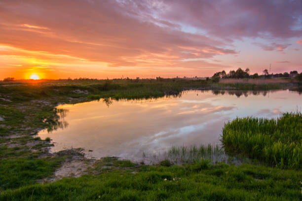 istock colorful cloudy sunset at countriside lake 830268988