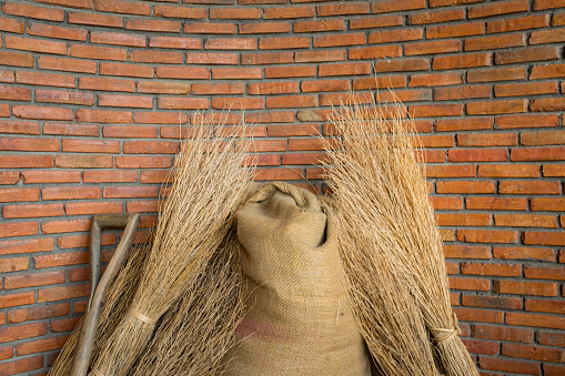 brick wall with hemp sack of seed and dried rice