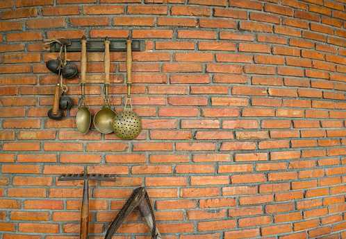 Brick wall with a spade and ladle hanging