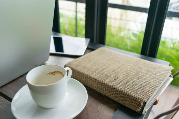 istock coffee, diary book, laptop and notepad on table in cafe 830278702
