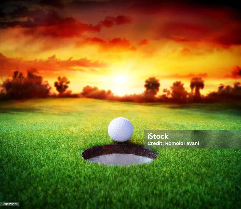 Golf Ball In Hole - Golfing Sport Target Concept - Ball On Putting Green In Hole Golf Ball Stock Photo