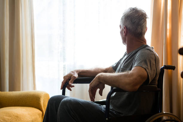 istock Senior man looking away while sitting on wheelchair 830299522