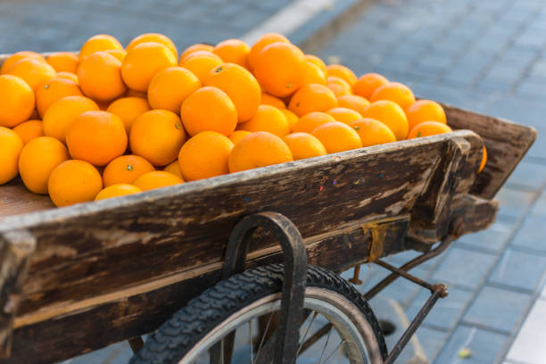 istock Fresh oranges on vintage wooden cart 830306154
