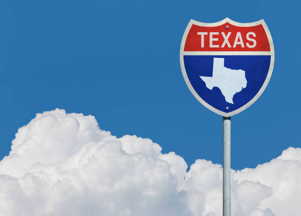 istock Highway sign for Interstate road in Texas with map in front of clouds 830313814