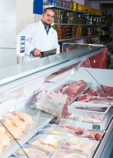 istock Butcher cutting fresh lamb meat 830314866