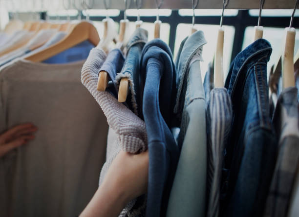 istock Hand selectng a cloth in a shop 830320064