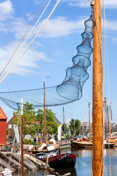 Wooden mast with fish pot in the harbor of Spakenburg in the Netherlands.
