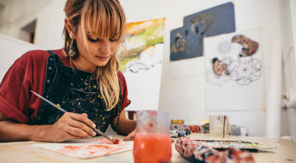 istock Female artist painting in studio 830327806