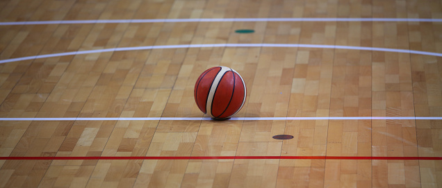 basketball in the basketball court with a wooden parquet and game lines