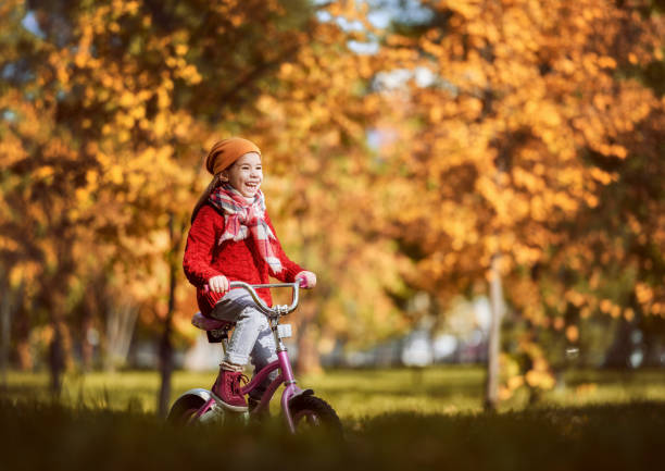 istock girl walking in autumn Park 830337998