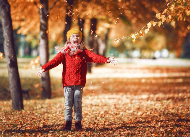 istock girl walking in autumn Park 830338144