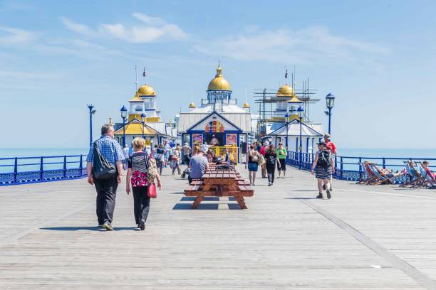 Eastbourne, United Kingdom - June, 01, 2017: Pier Eastbourne, East Sussex, United Kingdom People walking and relaxing on the Pier of Eastbourne in East Sussex, United Kingdom eastbourne pier photos stock pictures, royalty-free photos & images