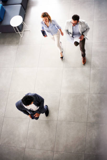 istock Business people ion work. Activity business people walking trough building. 830346464
