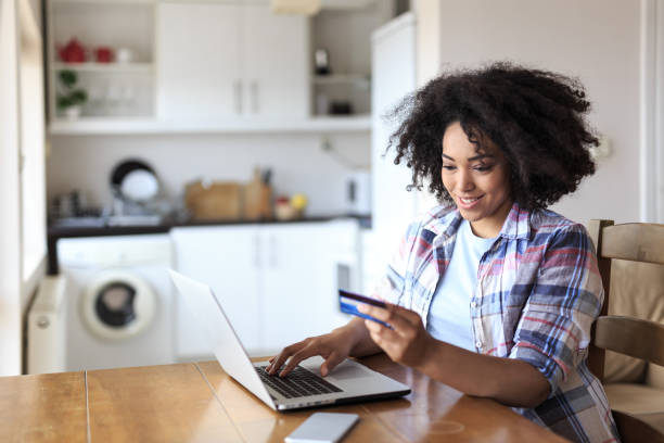istock Woman using credit card for home shopping 830359288