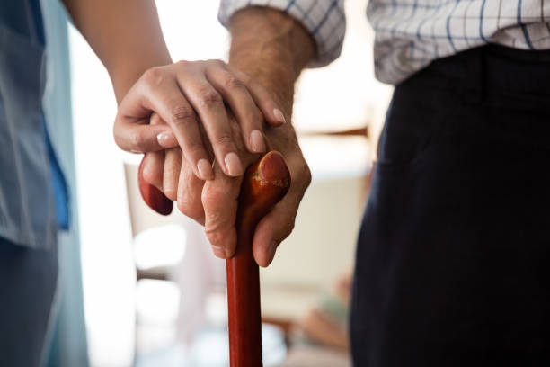 女医と歩行杖を保持している年配の男性の手をトリミング - human hand aging process senior adult cane ストックフォトと画像