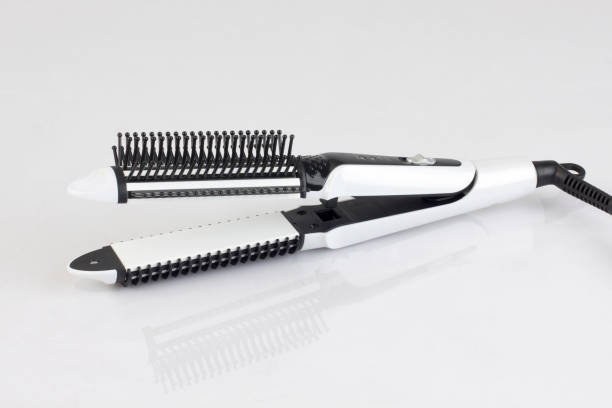 istock White hair straightener with comb isolated 830365796