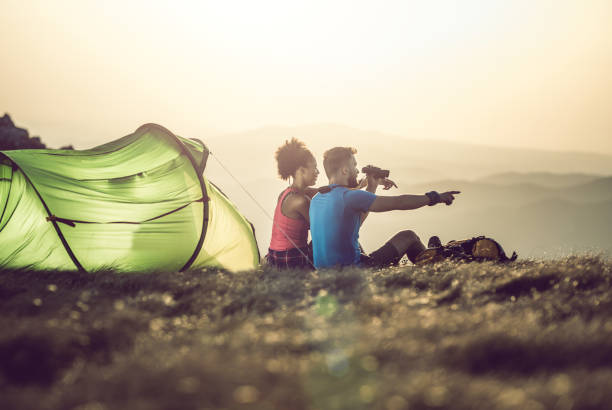 Young Couple Camping on Top of Hill